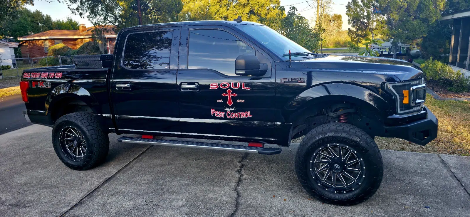 Black branded pest control pickup truck parked on a driveway — Soul Pest Control, Polk County, FL
